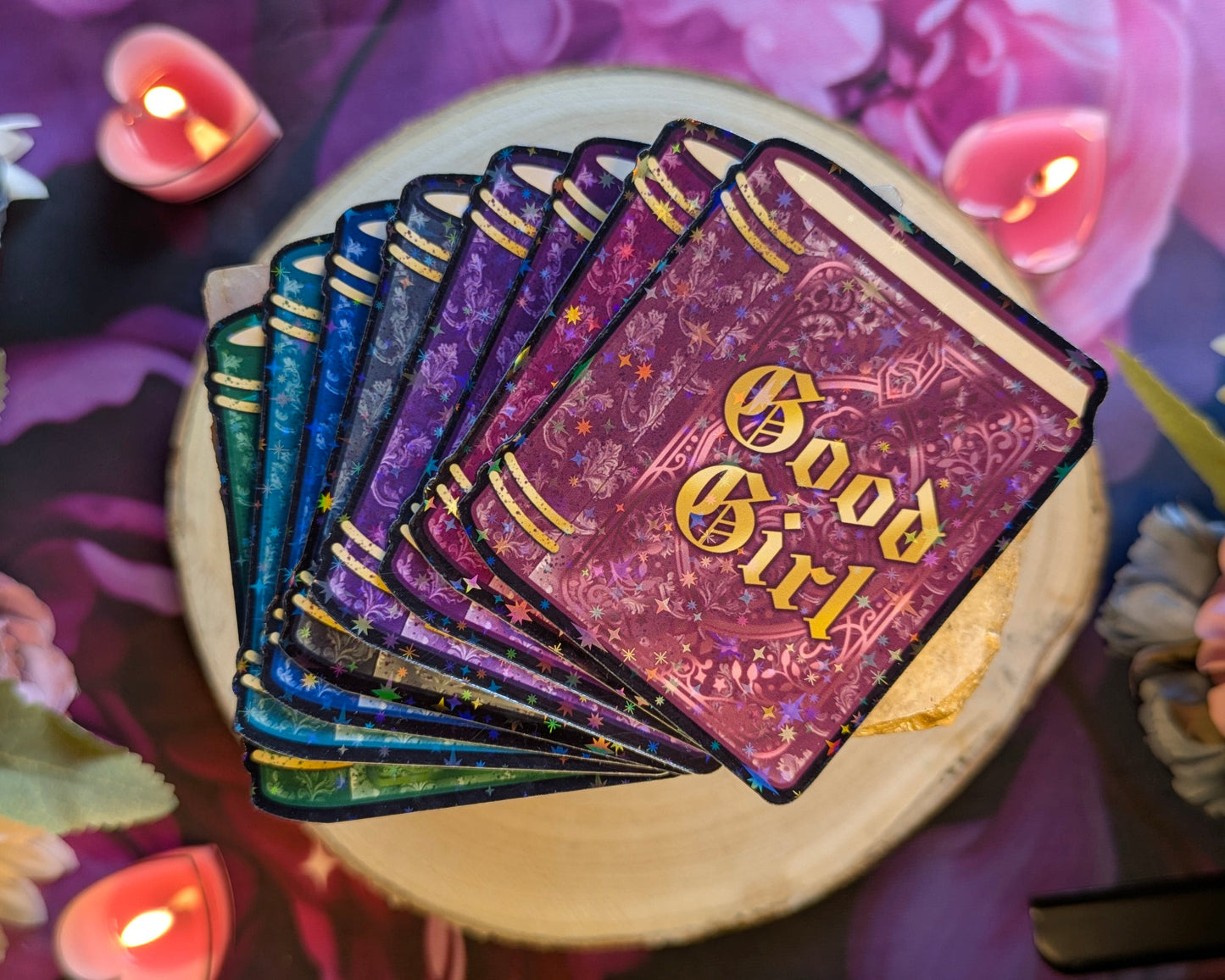 Stack of Stickers with 'Good Girl' design on a wooden surface with candles in the background