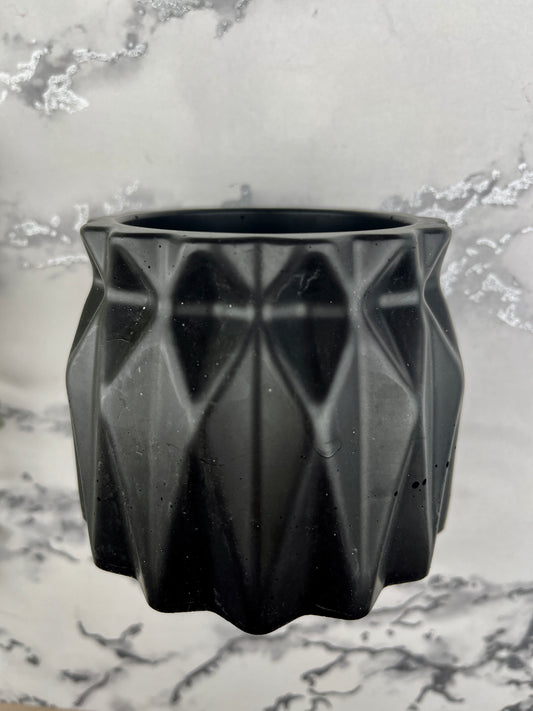 Side view of black faceted plant pot